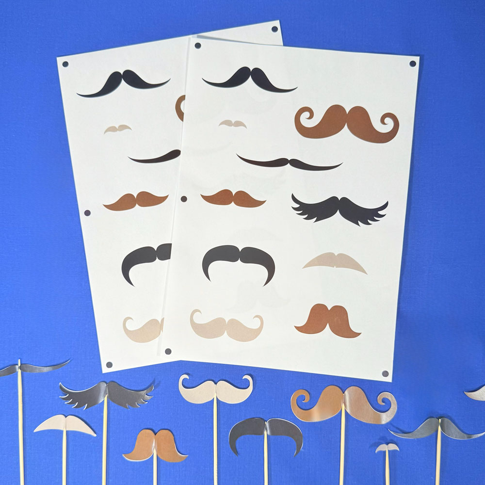 Picture showing moustache stickers stuck on skewers to use as party props