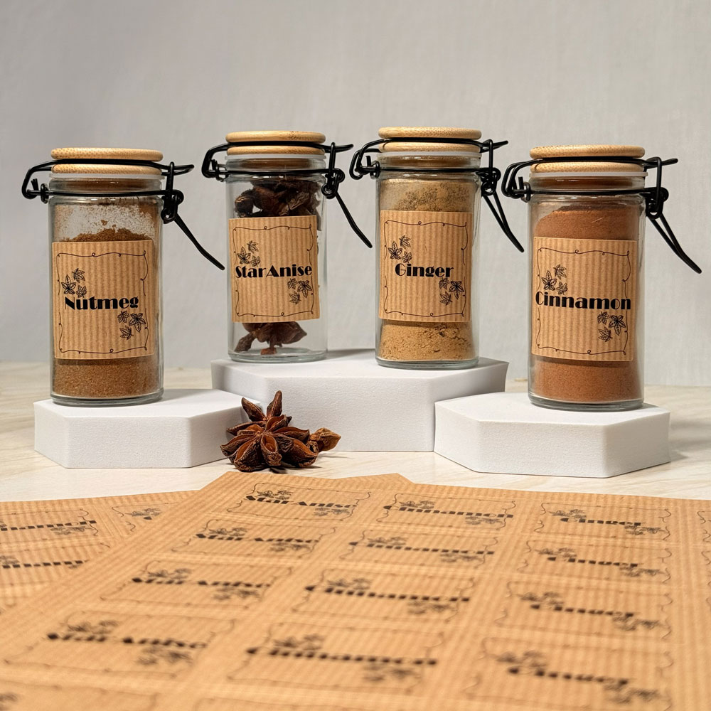 Picture showing four spice jars labelled as nutmeg, star anise, ginger and cinnamon